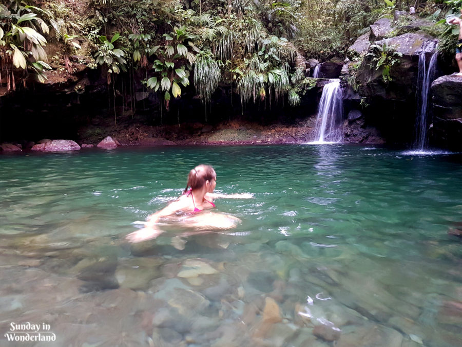 A girl swimming in a natural basin Cascade aux Ecrevisses in Basse-Terre, Guadeloupe