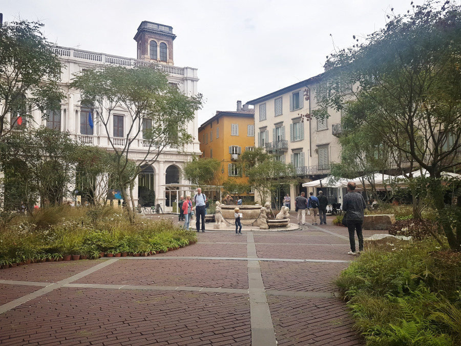 Piazza Vecchia in Bergamo filled with plants during a greenery festival