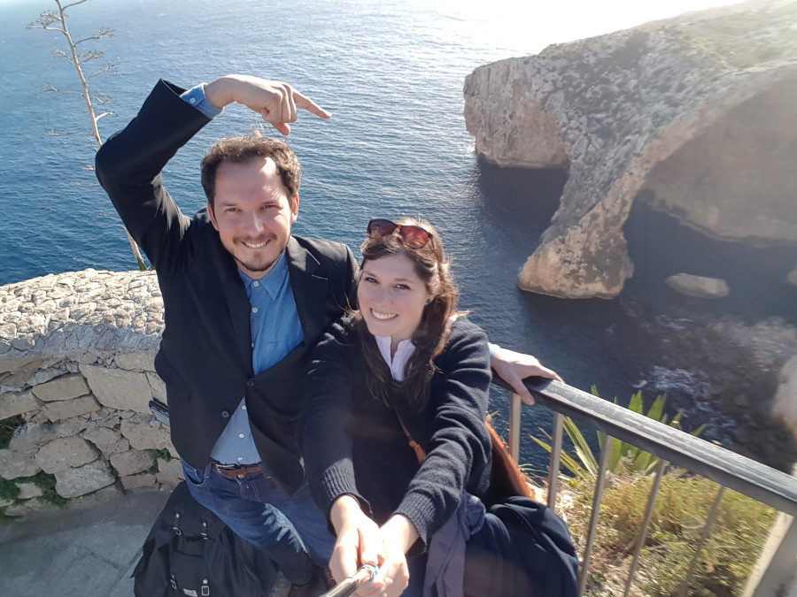 A couple taking a selfie in the Blue Grotto viewpoint, in Malta