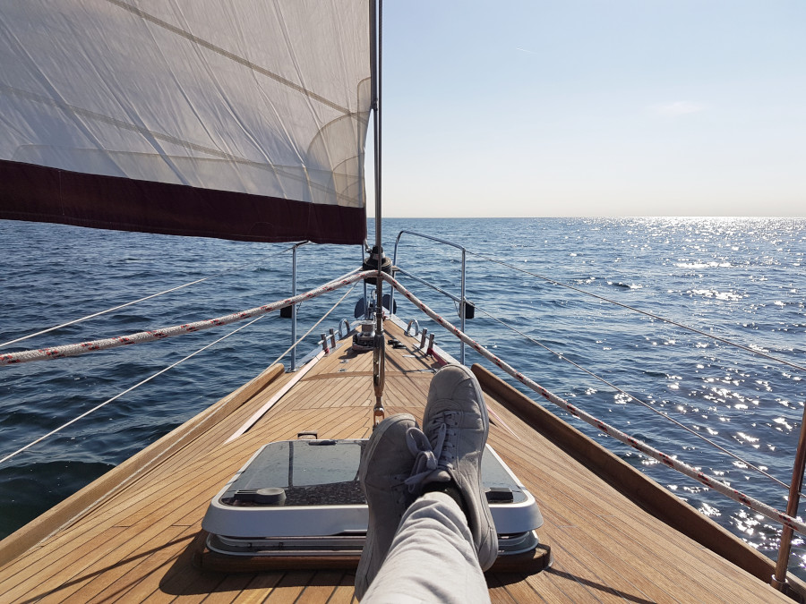 Sitting on a deck of a sailboat on a sea in a sunny day