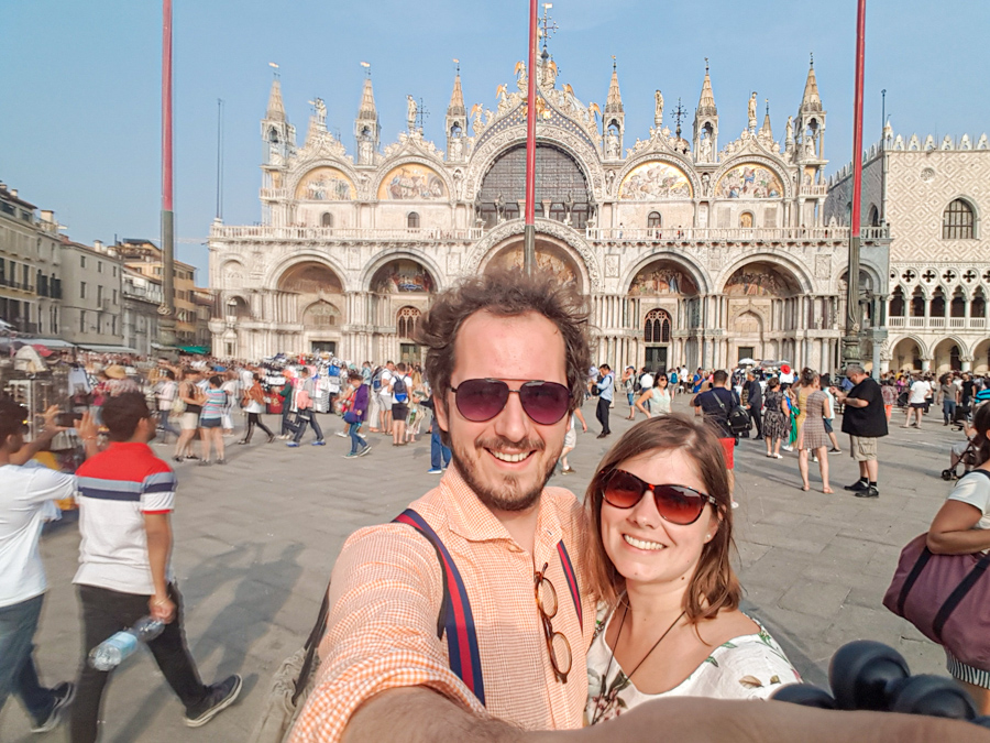 A couple in Venice for the weekend taking selfie at St Mark's Square