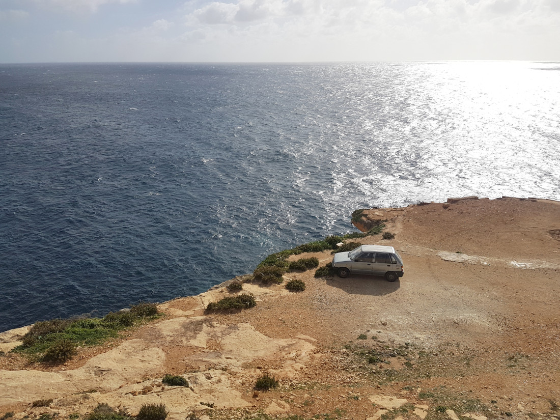 An old car on the rock shelf above the sea - what to see in Malta in winter?